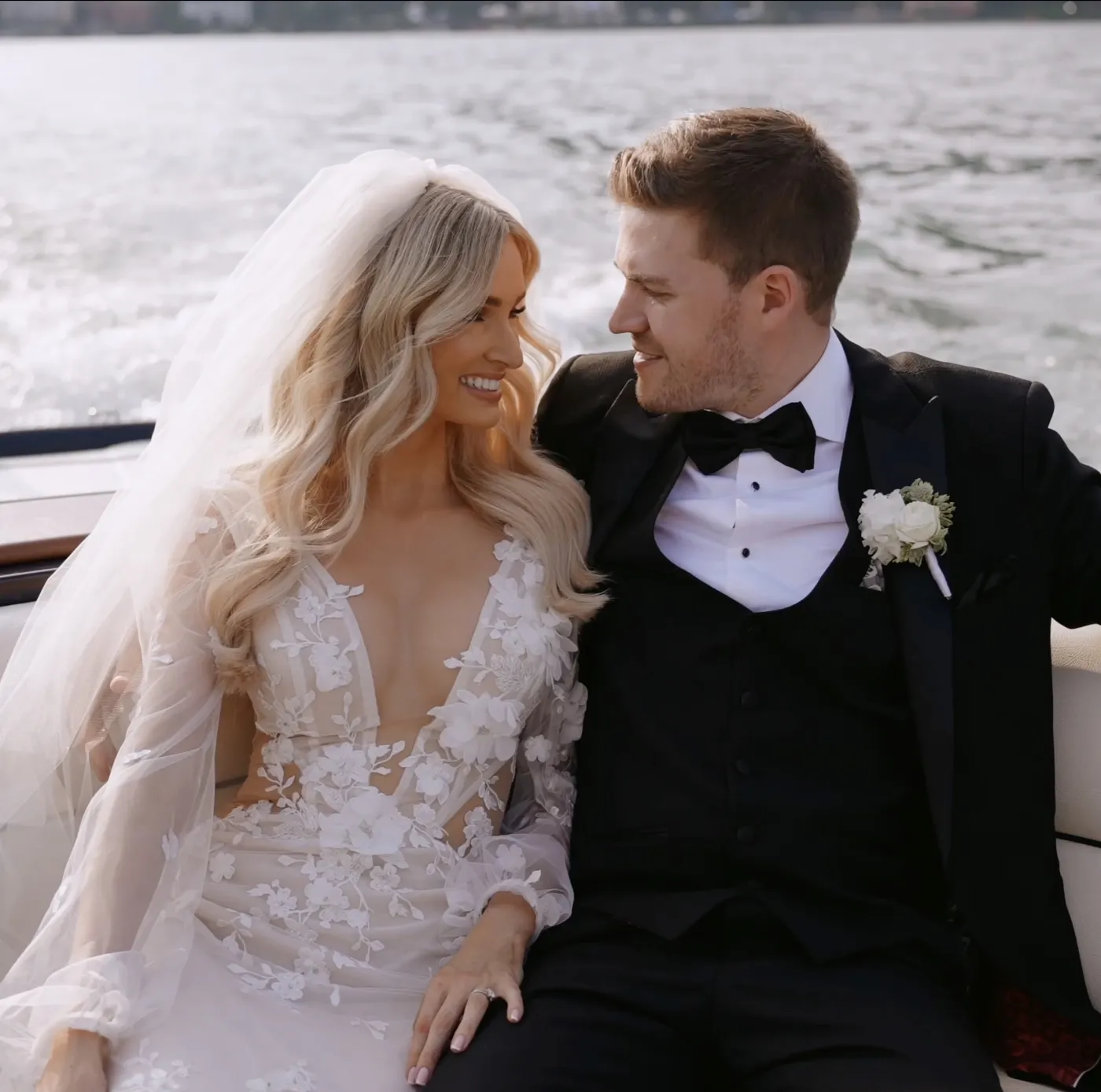 Bride and groom laughing on a boat