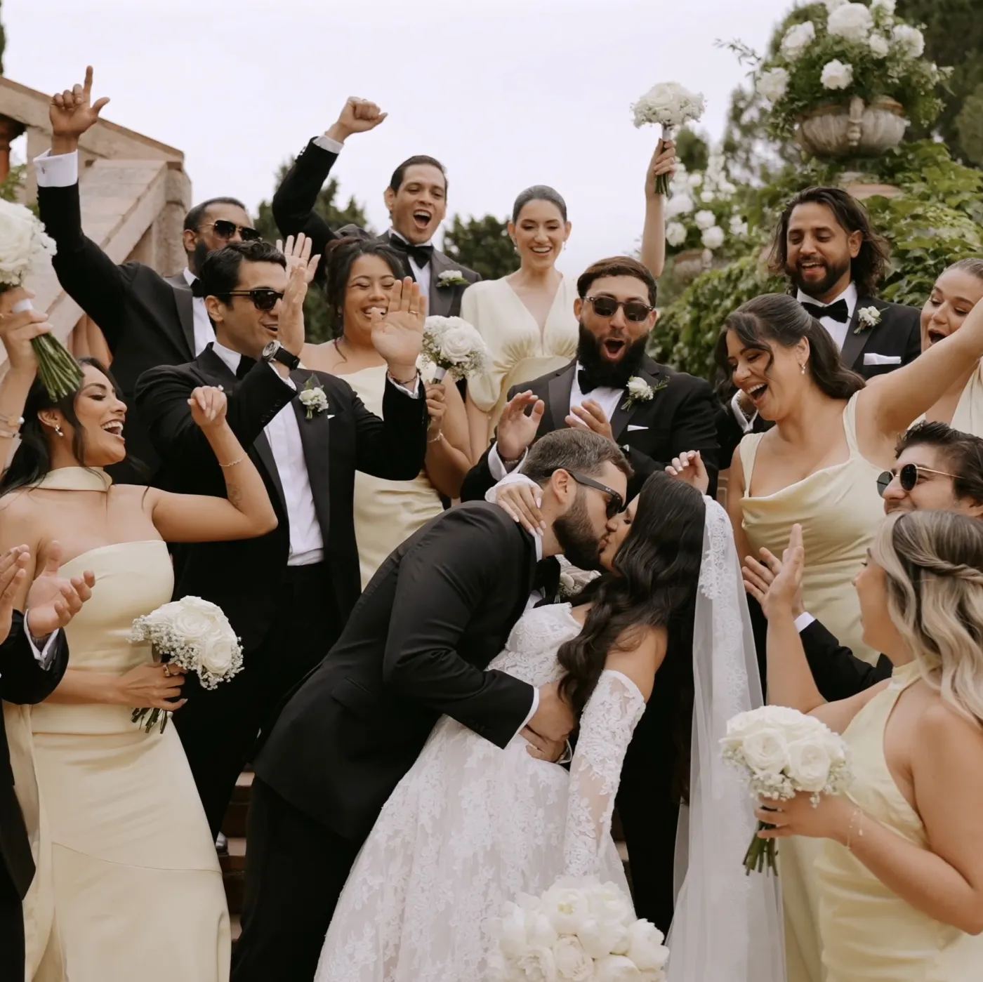 Wedding guests celebrating around the couple, from a PS Visuals film